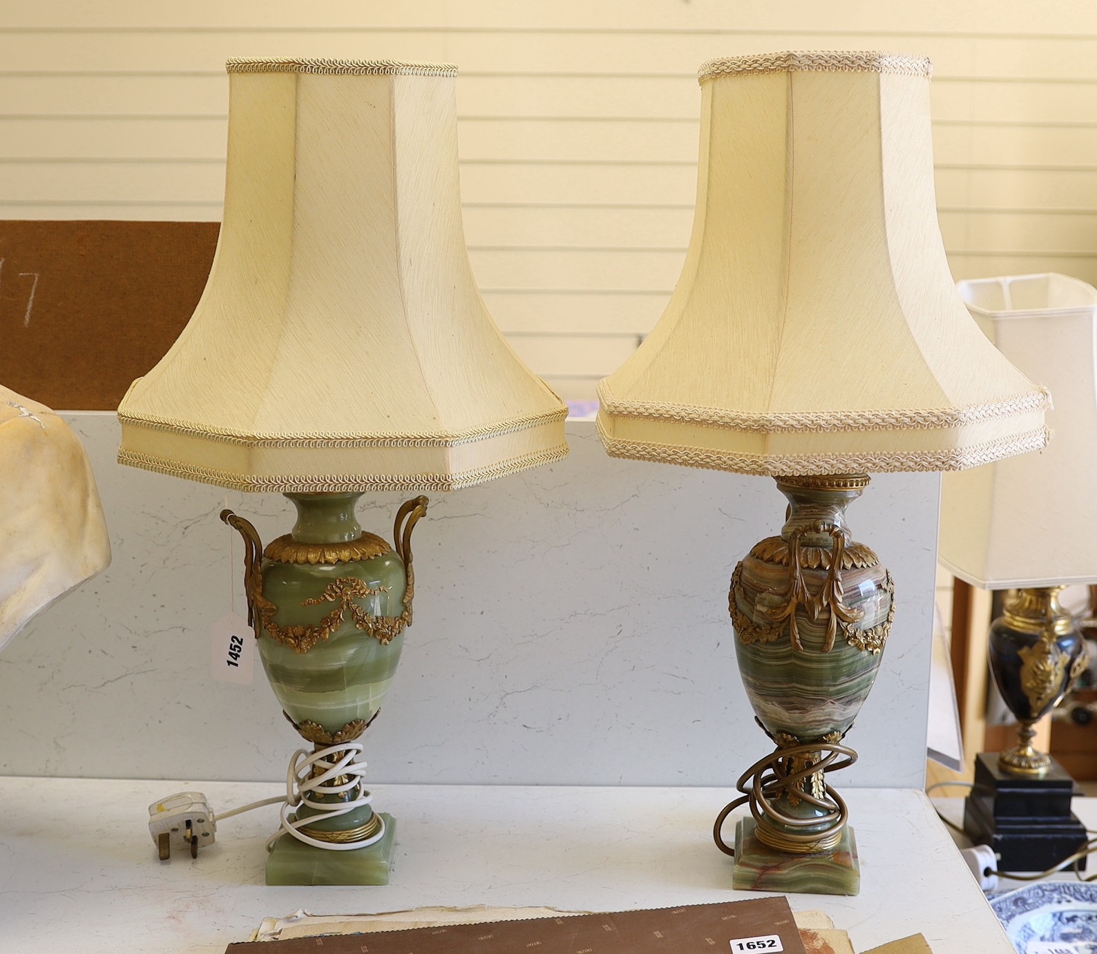 A pair of early 20th century brass mounted onyx urn shaped lamps, 35cm high not including light fitting or shade